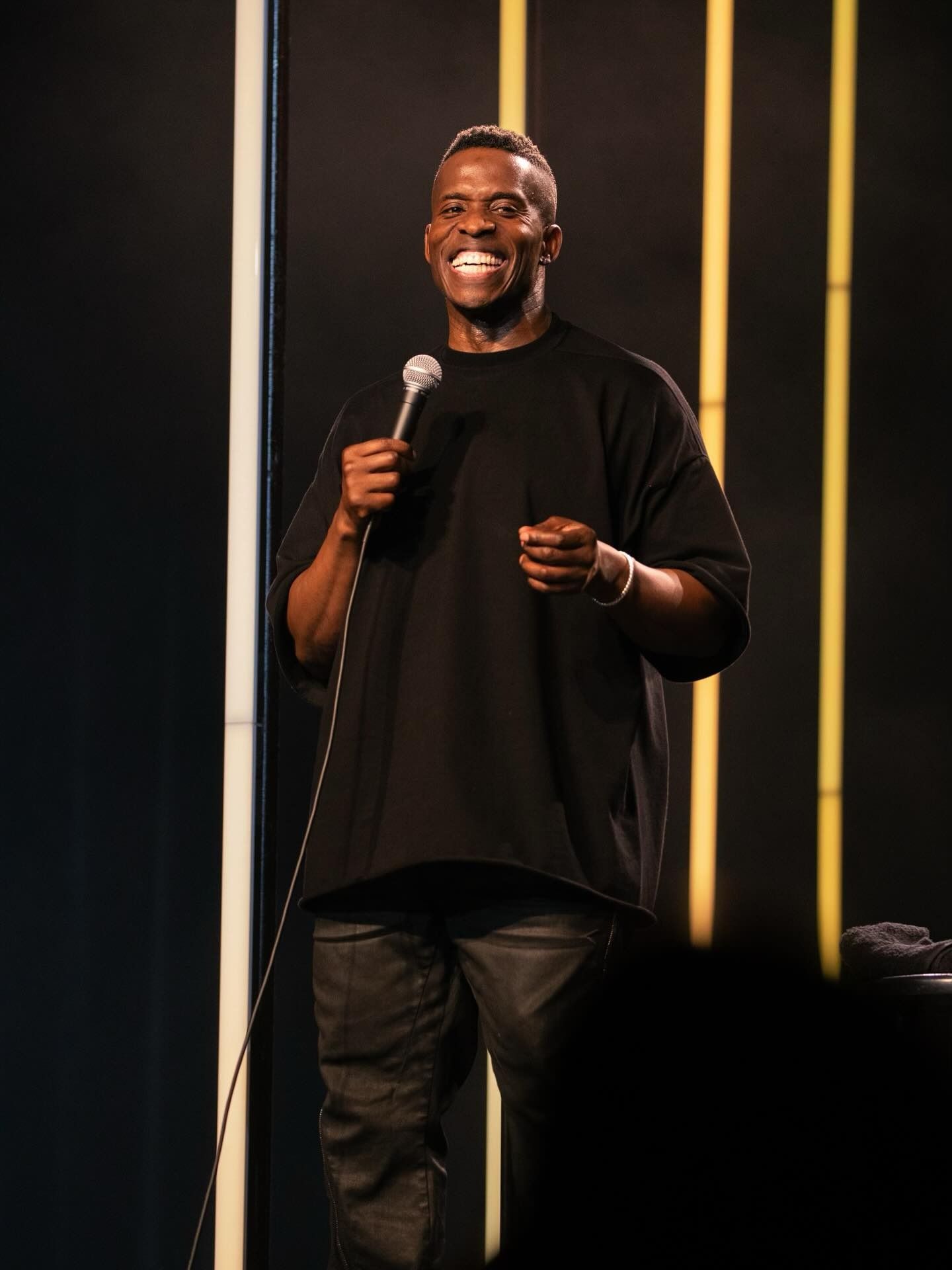 Comedian Godfrey performing on stage